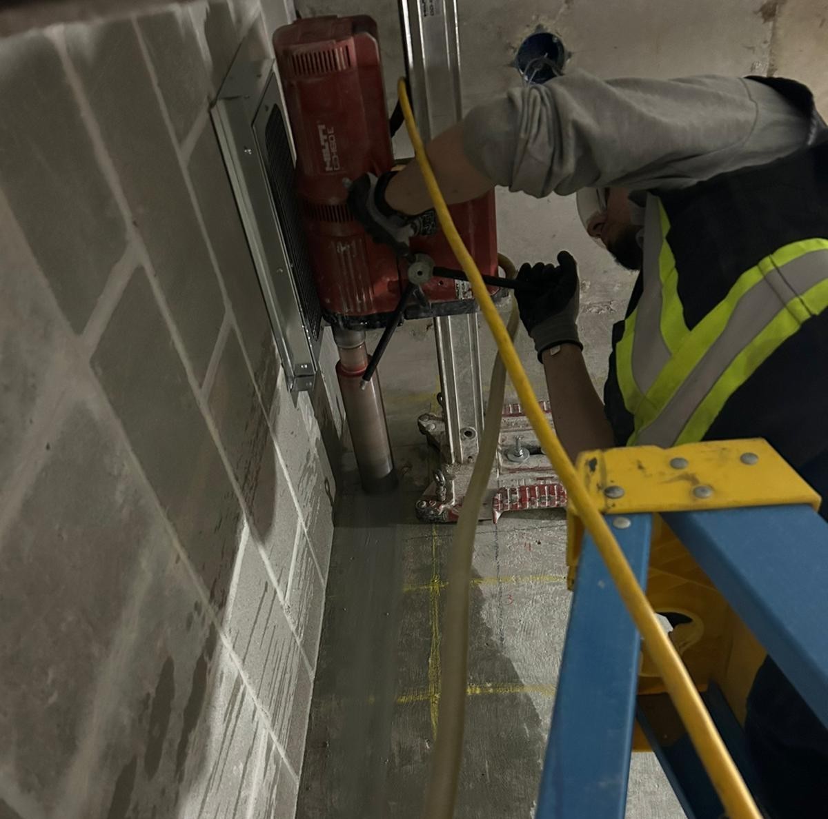 Professional concrete coring drill creating precise holes in concrete slab